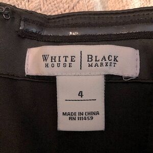 Black cocktail dress from WHBM with pleating on the bodice.